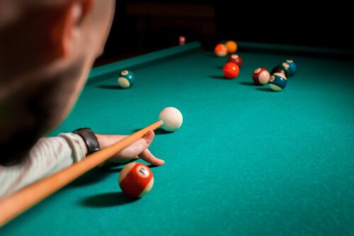 Fragment of the pool billiard game in process Fragment of the pool billiard game in process. American pool billiard. Pool billiard game. Billiard sport concept.